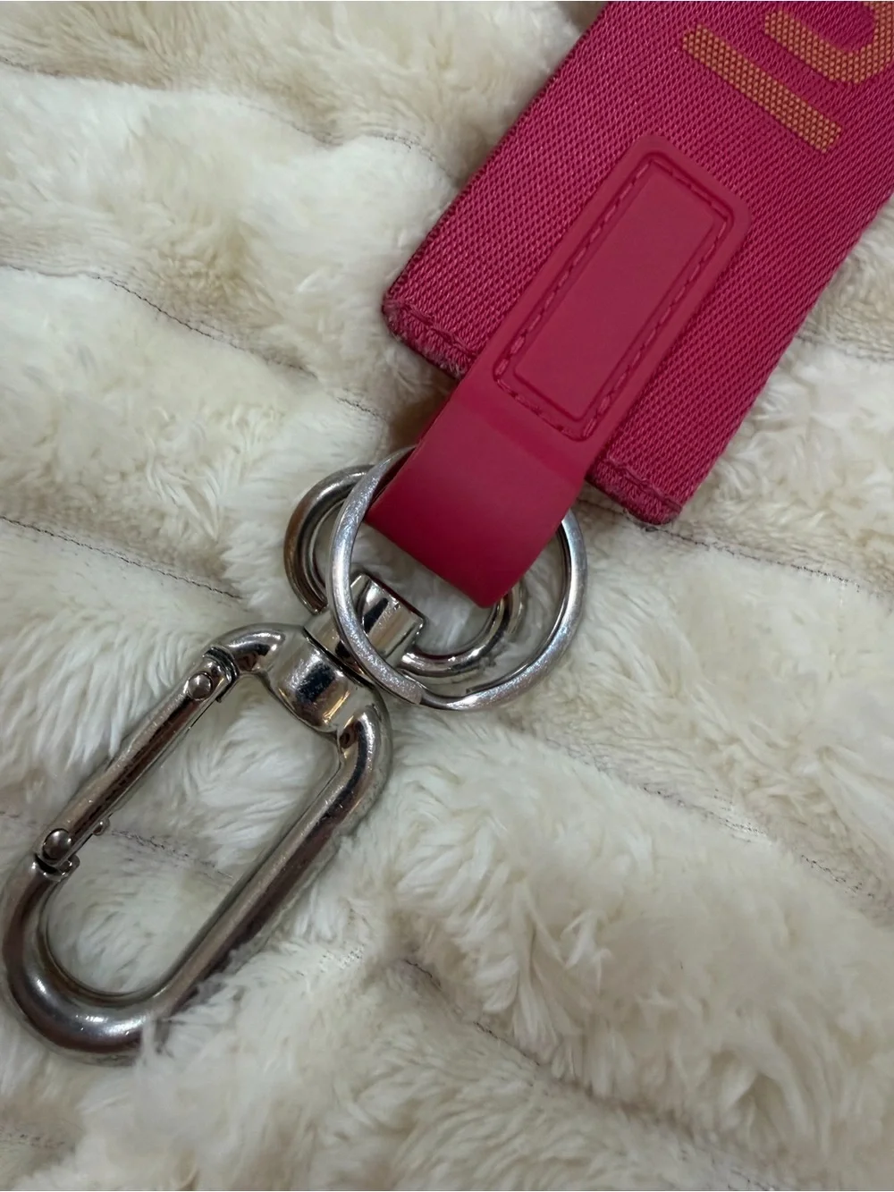 lululemon pink logo wristlet strap with orange lettering
